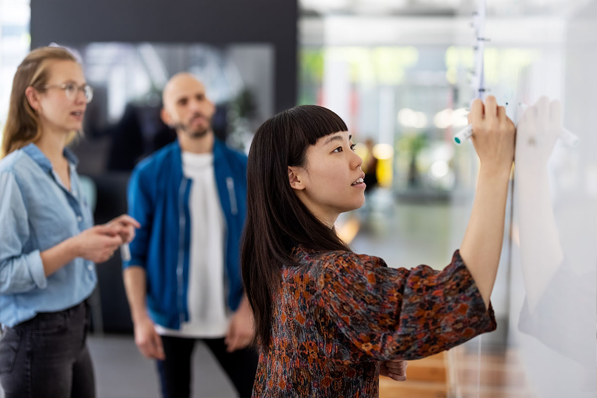 Grupo de funcionários treinando em um ambiente de workshop. 