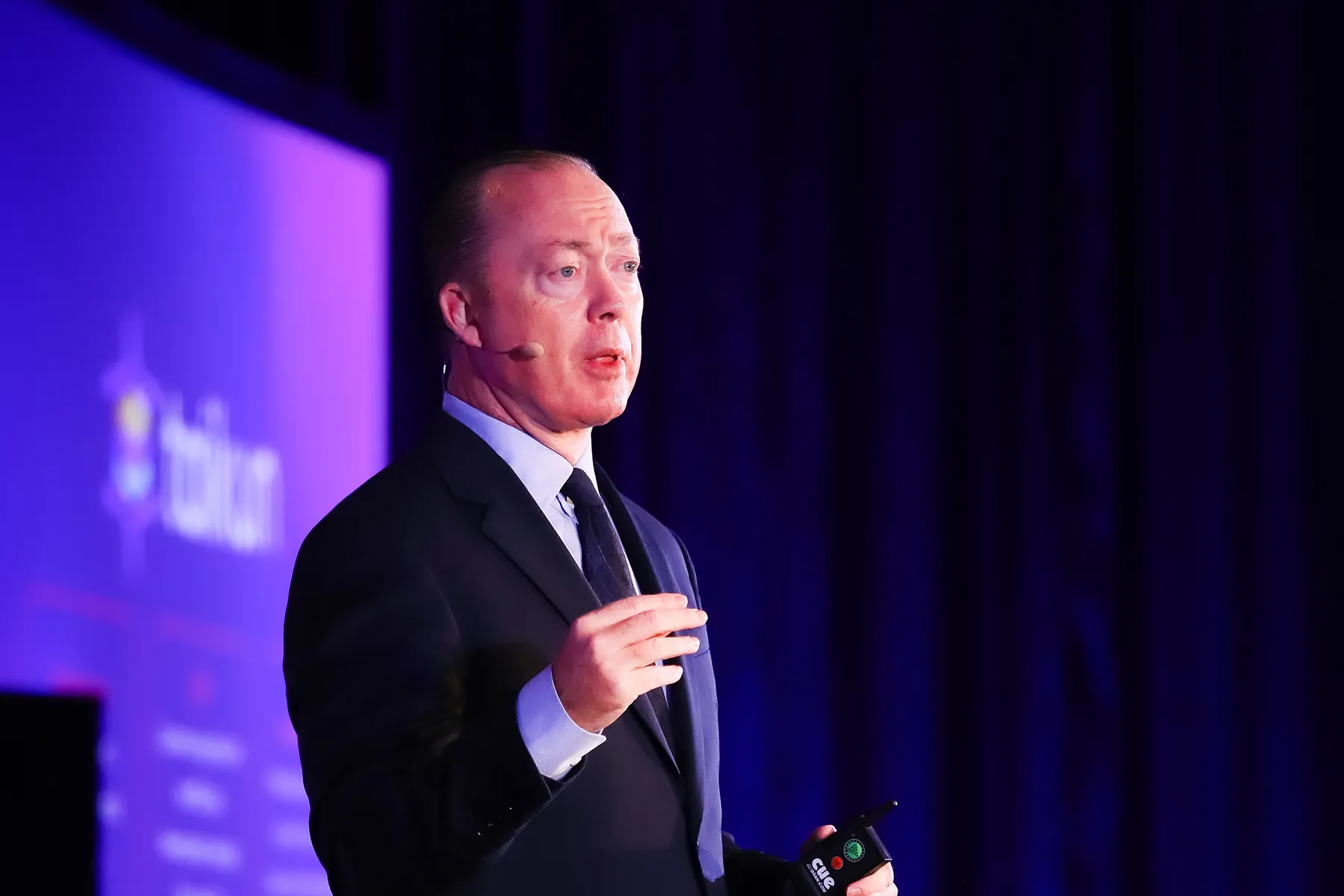 Frank O’Dowd speaking on stage with partners.