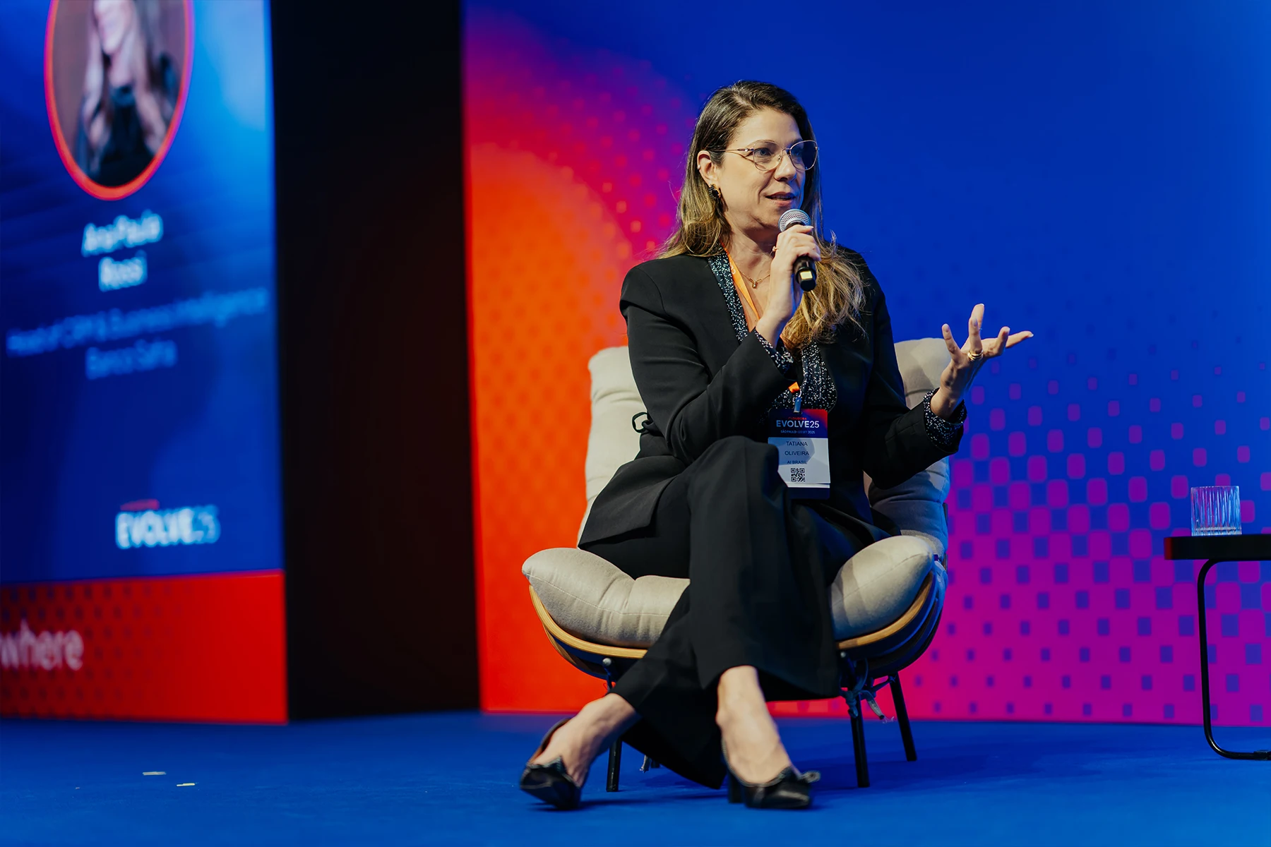Woman speaking during the panel session on stage.